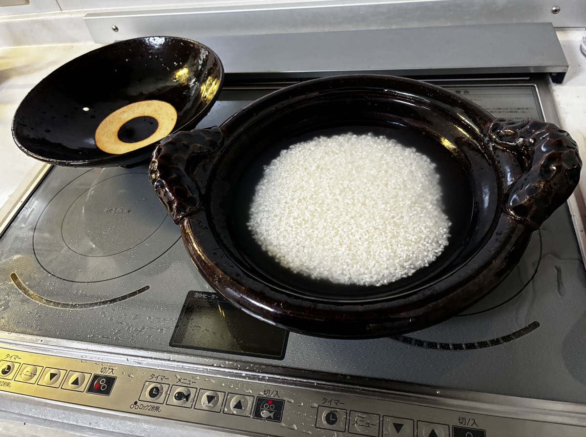 研いだ米を土鍋に入れて浸水させている様子